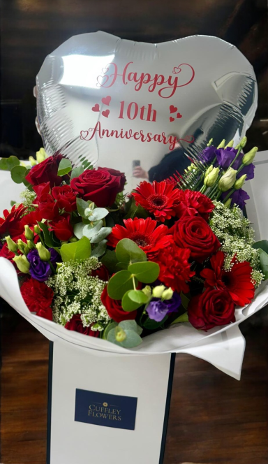 Personalised 18 inch Foil with Bouquet A bouquet of red and purple flowers with a silver heart-shaped balloon reading "Happy 10th Anniversary."