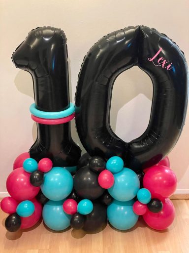 Double number balloon stack Black balloon numbers '10' surrounded by pink, blue, and black balloons.